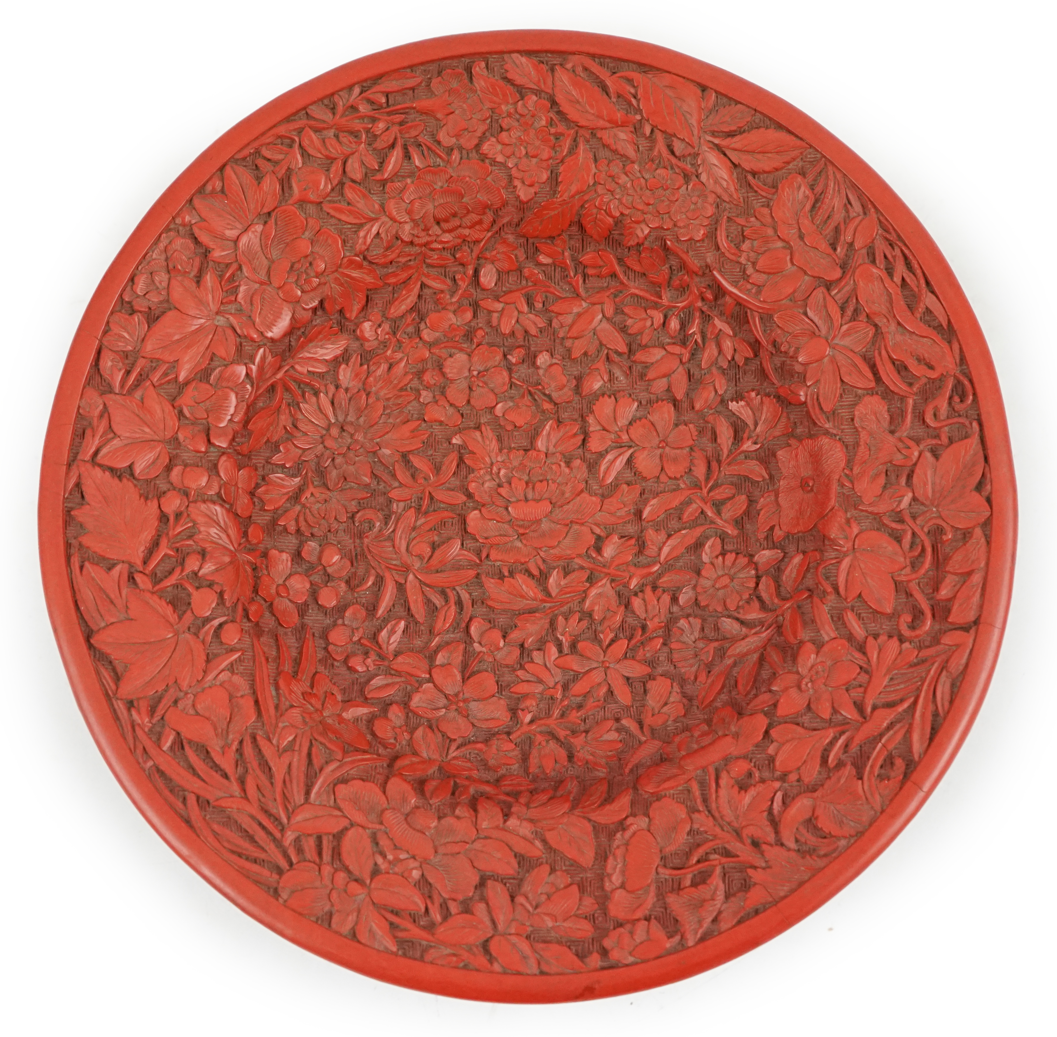 An unusual Chinese cinnabar lacquer ‘thousand flower’ footed dish, 18th/19th century